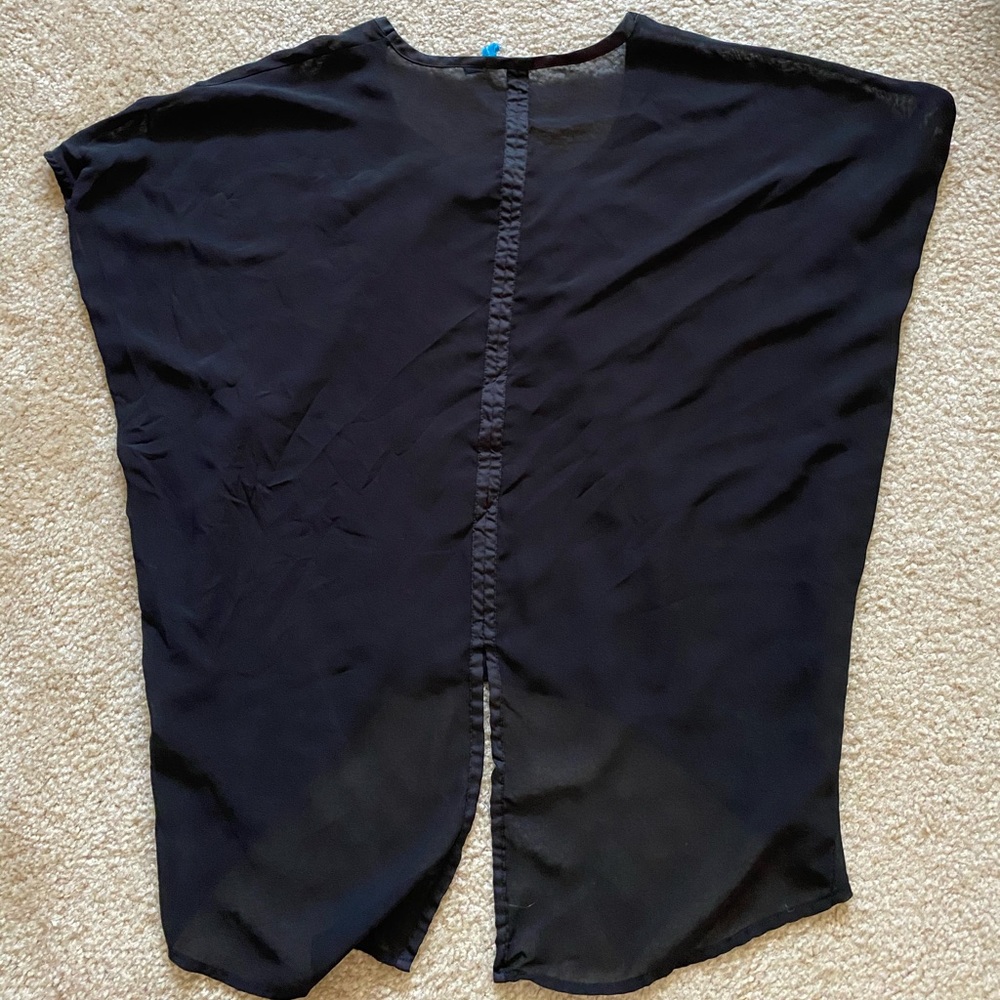 Short sleeve see-through black top with slit in the back at the bottom.